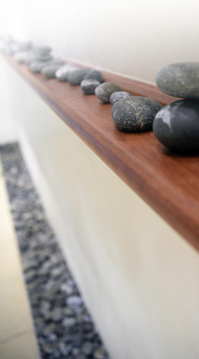 A series of stones on a bench. 